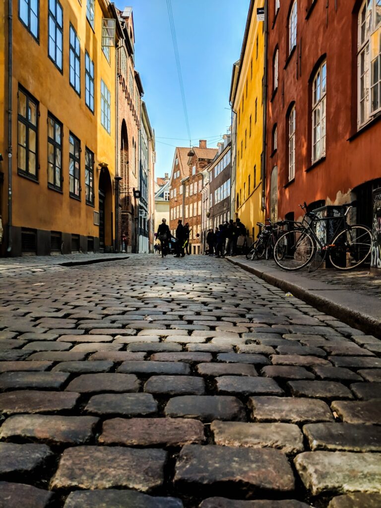 low angle view photography of street and parked bikes