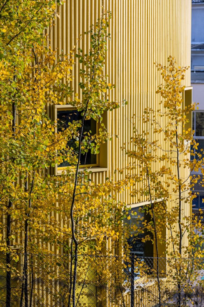 A tall building with a bunch of trees in front of it