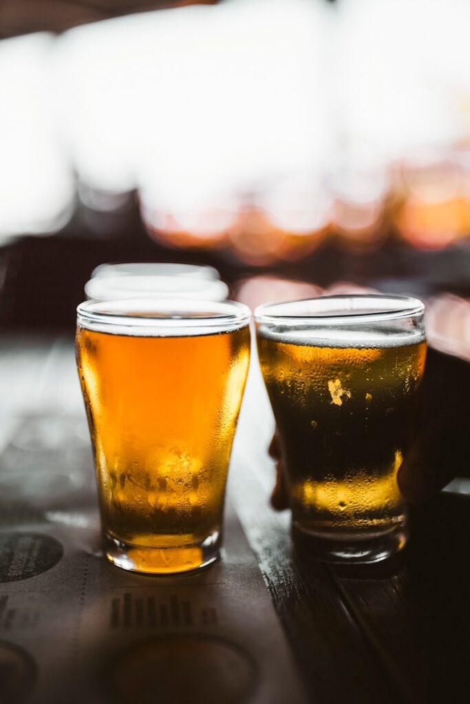 clear drinking glass with beer on black table